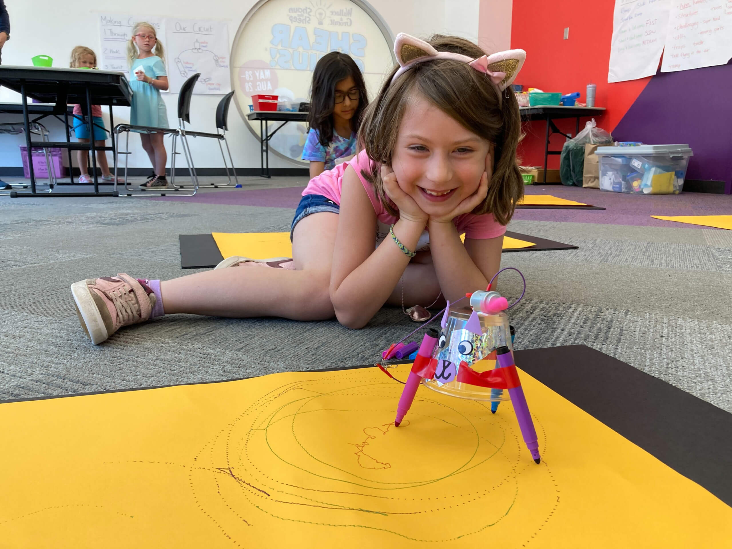child smiling with science experiment