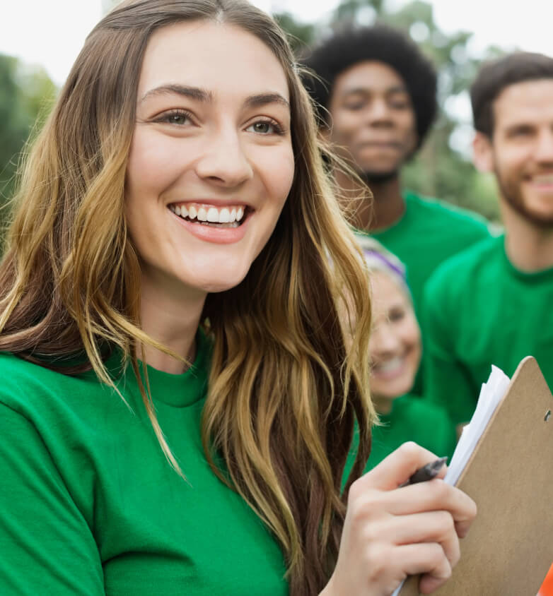 Closeup of woman smiling with others blurred in the background